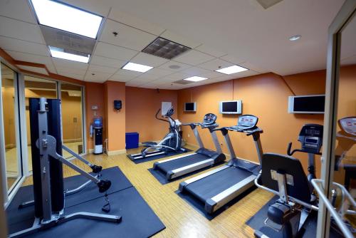 a gym with treadmills and ellipticals in a room at Beacon Hotel & Corporate Quarters in Washington