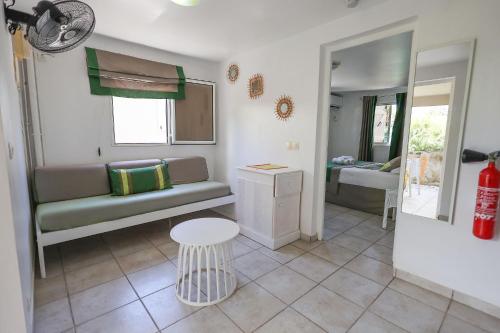 a living room with a couch and a table at Village de Bragelogne in Saint-François