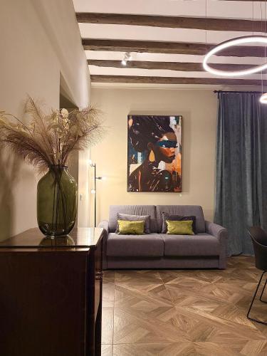 a living room with a couch and a table at Chiara Home in Udine