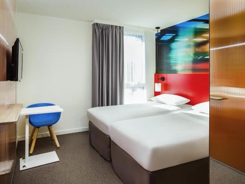 Ένα ή περισσότερα κρεβάτια σε δωμάτιο στο Ibis Styles Mulhouse Centre Gare