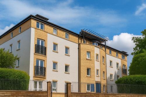 an apartment building with a fence in front of it at Edinburgh Aparthotel in Edinburgh