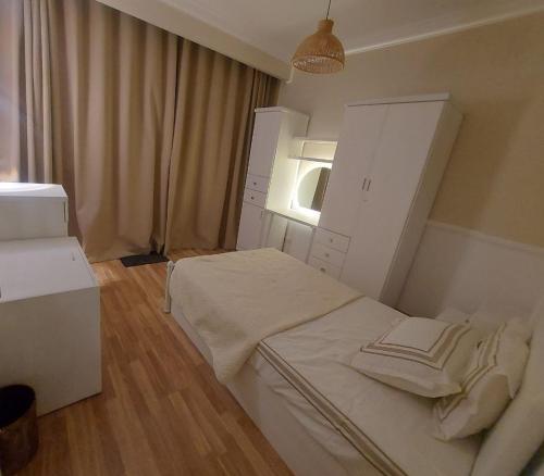 a small bedroom with a bed and a window at Apartment with nice garden in Sheikh Zayed