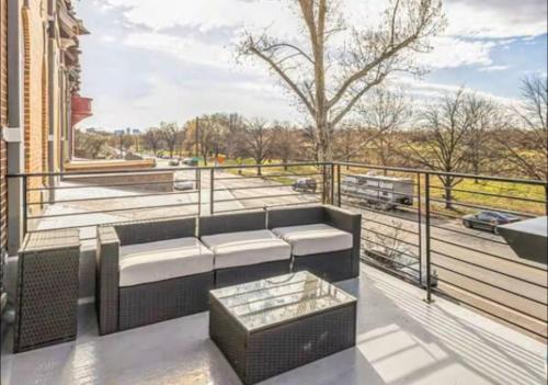 a balcony with a couch and a view of a street at Studio w Terrace - Street Parking -10 min to DT in Philadelphia