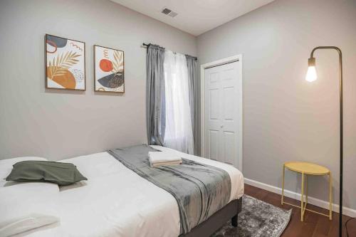 a bedroom with a bed and a window and a table at Charming Center City 2BR - Sleeps 8 people in Philadelphia