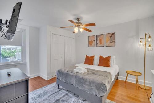 a bedroom with a bed and a ceiling fan at Huge and Sunny 1BR in Center City in Philadelphia