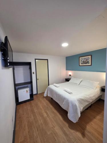 a bedroom with a large white bed in a room at Hotel Estrella in Viña del Mar