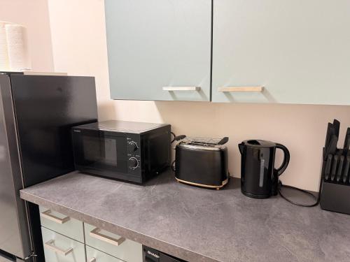 a kitchen counter with a microwave and a toaster and a toaster at DREAMZzz Marktblick - Altstadt Suite in Coburg in Coburg