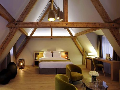 a bedroom with a large bed in a attic at 5 Terres Hotel & Spa - MGallery Collection in Barr