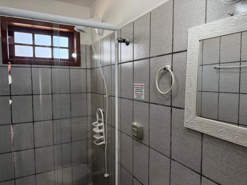 ボンビーニャスにあるResidencial Recanto do Sossegoのシャワーと鏡付きのバスルーム