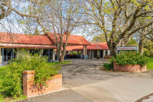 a building with a sign in front of it at ASURE Oak Estate Motor Lodge in Greytown