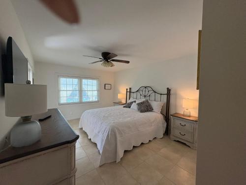 a bedroom with a bed and a ceiling fan at First-Floor 2BR 2BA Condo in Old Naples Steps to 5th Ave South & the Beach in Naples