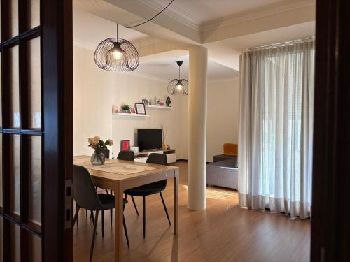 a dining room and living room with a table and chairs at B Apartamentos Castelo in Viana do Castelo