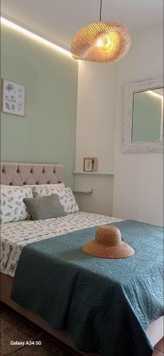 a bedroom with a bed with a hat on it at Verdalia Private Holiday House in Stavrákia