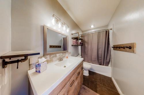 a bathroom with a sink and a toilet and a mirror at Take the Mountain View in Silverthorne