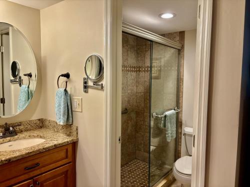 a bathroom with a shower and a sink at Belair Lane condo community pool managed by Sky Run Naples in Naples