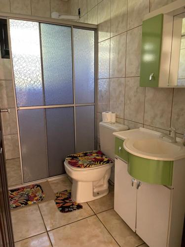 a bathroom with a toilet and a sink at Hostel e Pousada Vó Lili in Joinville