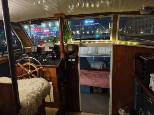 a boat with a room with a bed and windows at Downtown Boat-Apartment in Gothenburg
