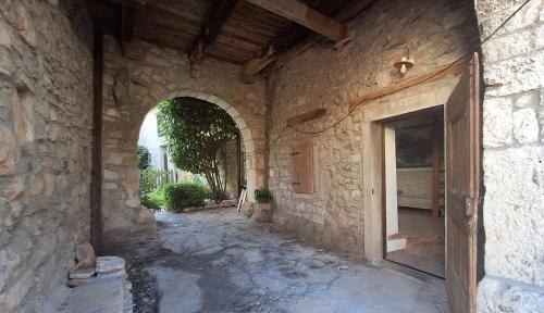 an entrance to a stone building with a doorway at Sailor Nest - Casetta carsica Aurisina in Aurisina
