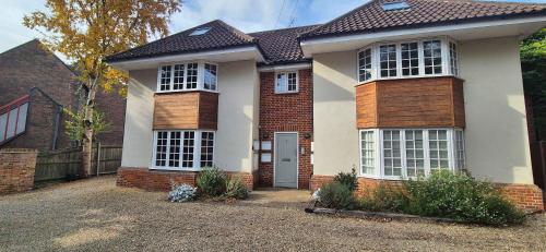 a large white house with a red brick at The Penthouse in Norwich