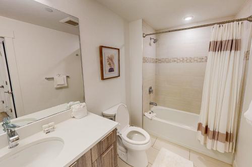 a bathroom with a toilet and a sink and a shower at Blue River Dream in Silverthorne