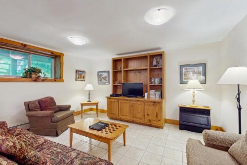 a living room with a couch and a tv at Latitude Adjustment in Jay