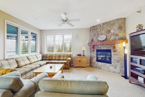 a living room with a couch and a fireplace at Kestrels #18 in Morses Mill