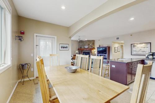 a kitchen and dining room with a wooden table and chairs at Kestrels #18 in Morses Mill