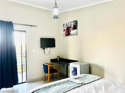 TV a/nebo společenská místnost v ubytování TLS Cottages