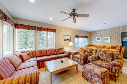 a living room with couches and a table at Falcon's Unit #4 in Morses Mill