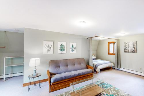 a living room with a couch and a bed at Edson Hill Getaway #4 in Stowe Fork
