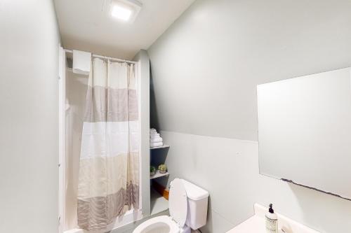 a white bathroom with a toilet and a shower at Edson Hill Getaway #4 in Stowe Fork