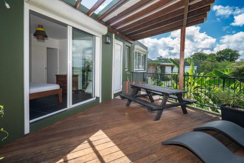 a wooden deck with a bench and a picnic table at Appartement Canne Noire in Richemont