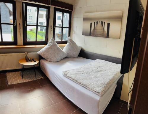 a room with a couch in a room with windows at Fewo Goldstück in Willingen