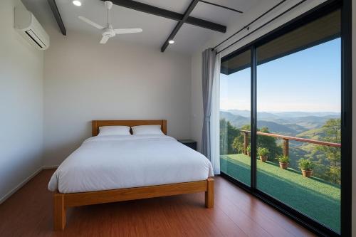 a bedroom with a bed and a large window at บ้านสวนเอลเลน in Ban Huai Khai
