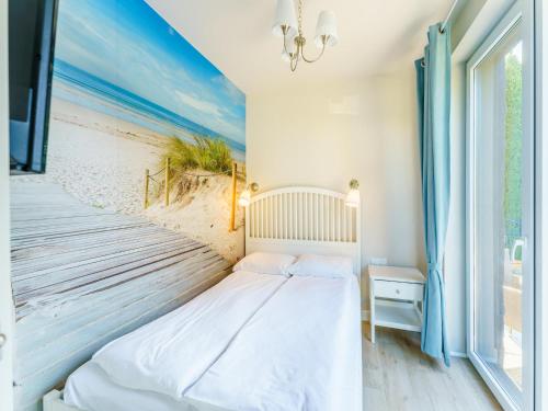a bed in a room with a beach mural at House in Grzybowo near the beach, private sauna in Grzybowo