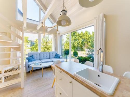 a kitchen and living room with a couch and a table at House in Grzybowo near the beach, private sauna in Grzybowo