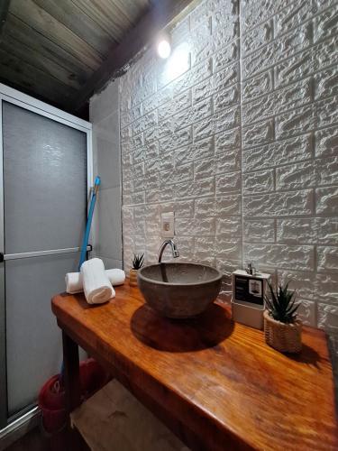 a bathroom with a bowl sink on a wooden counter at La casita in Barra de Valizas