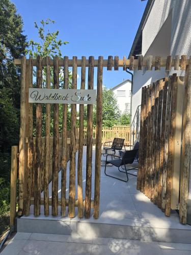 a wooden fence with a sign that reads wilderness safe at Wald Villa Schönau in Schönau an der Brend