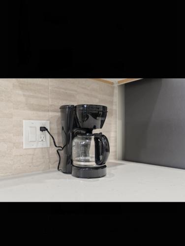 a coffee maker sitting on top of a counter at Modern 2 bedroom 1 bath unit 2 Near Airport, Xfinity Arena and Eagles Stadium in Philadelphia