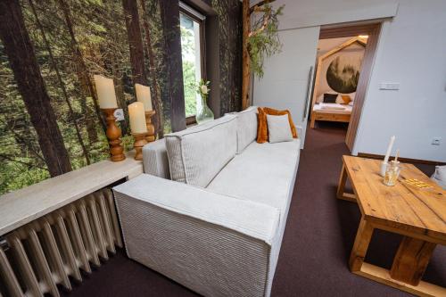 a living room with a couch and a table at Wald Villa Schönau in Schönau an der Brend