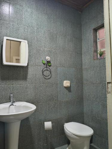 a bathroom with a toilet and a sink at Pousada Barão de Santa Helena in Juiz de Fora