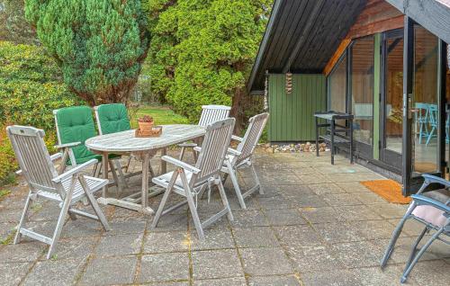 a patio with a table and chairs on a patio at 2 Bedroom Gorgeous Home In Græsted in Græsted