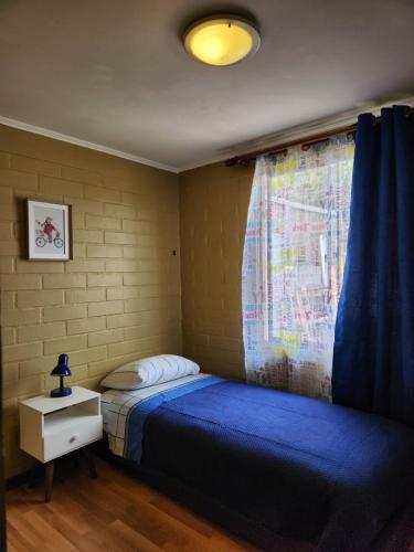 a bedroom with a blue bed and a window at Cómo en casa y cerca del centro in Santa Cruz