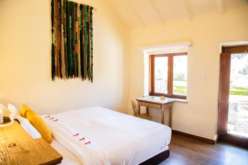 a bedroom with a bed and a window at Colca Lodge Spa & Hot Springs in Yanque