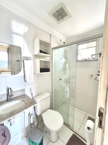 a bathroom with a shower and a toilet and a sink at Apartment in Ananindeua in Ananindeua