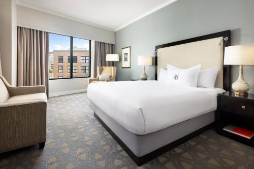 a bedroom with a large white bed and a window at Riverfront Hotel New Orleans in New Orleans