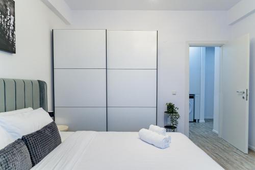 a white bedroom with a large white closet at My Happy Place - Craiova in Craiova