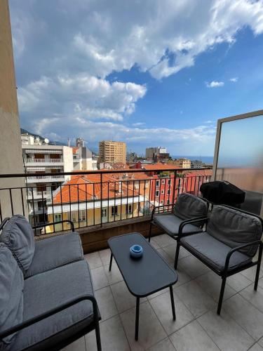 a balcony with couches and a table and a view at Super Monaco 2 in Beausoleil