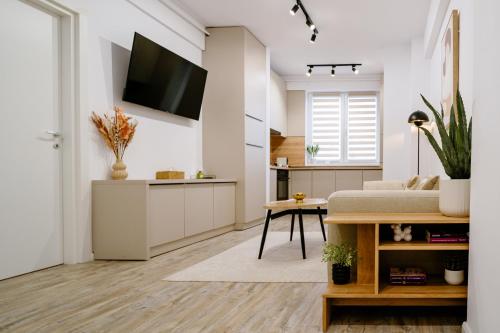 a living room with a bed and a kitchen at My Happy Place - Craiova in Craiova