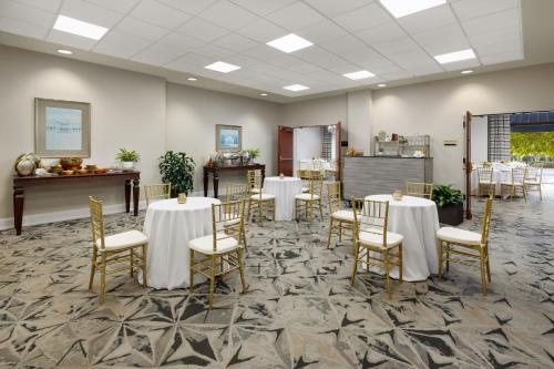 a banquet room with tables and chairs and a kitchen at Riverfront Hotel New Orleans in New Orleans